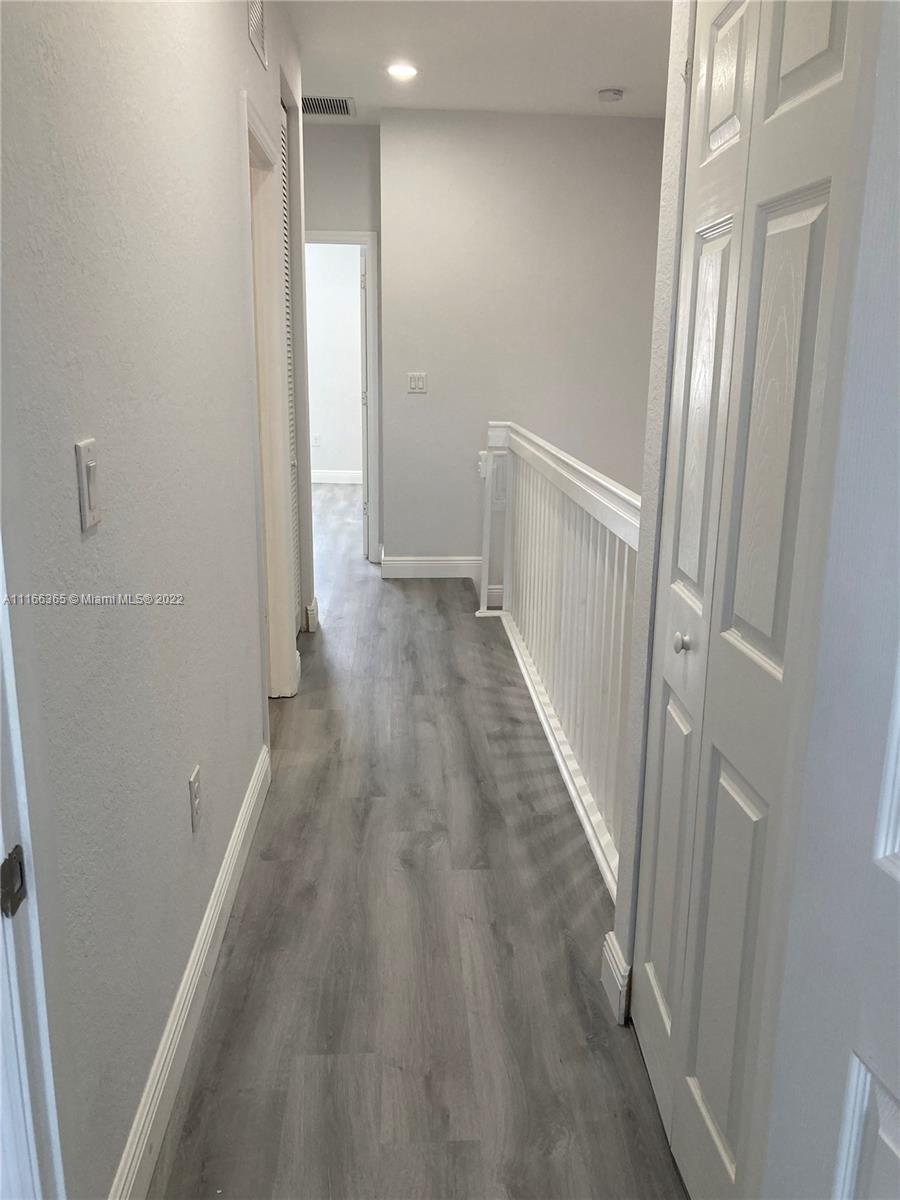 The Hammocks Miami, FL 33196 - Photo 20 of 27 a view of a hallway with wooden floor