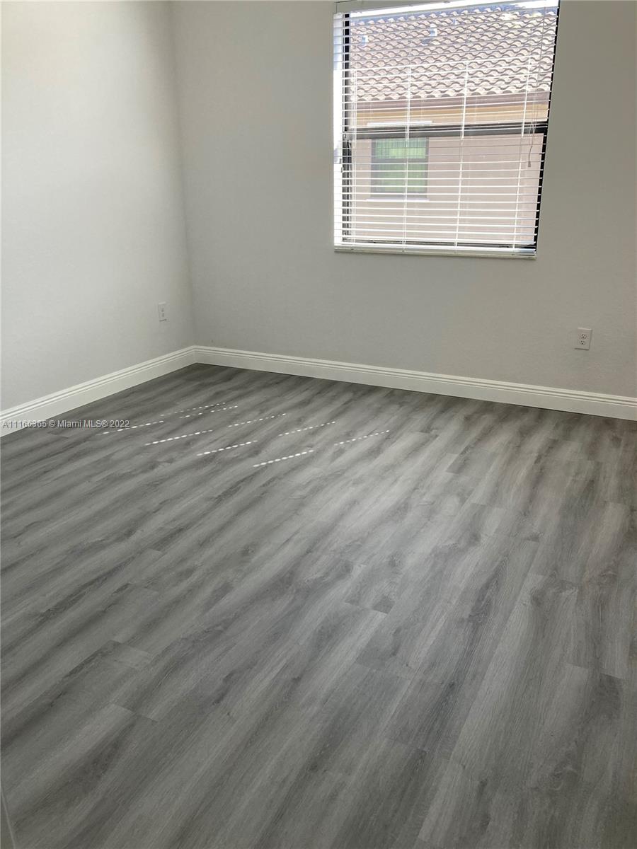 The Hammocks Miami, FL 33196 - Photo 21 of 27 an empty room with wooden floor and windows