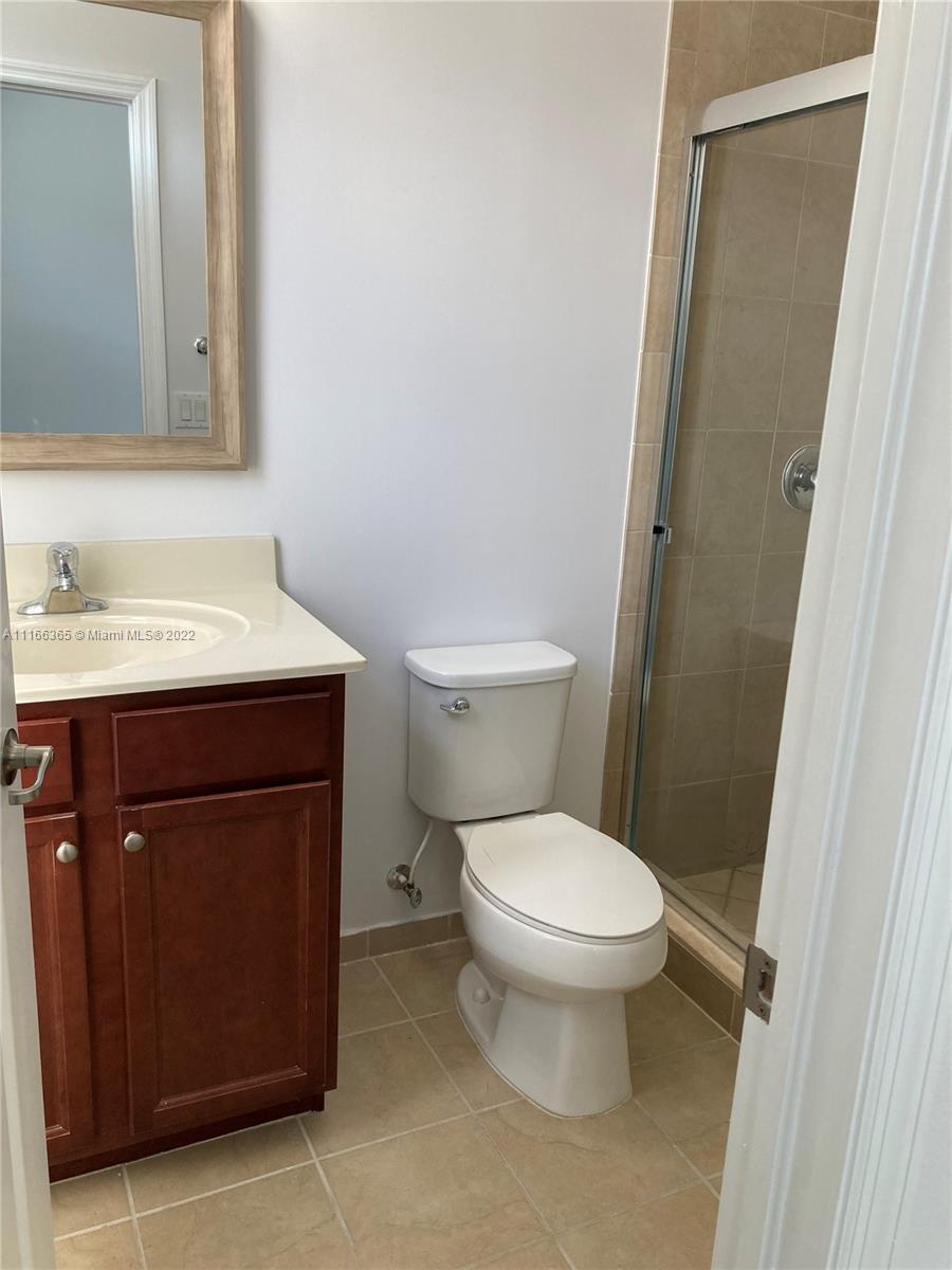 The Hammocks Miami, FL 33196 - Photo 22 of 27 a bathroom with a toilet sink vanity and mirror