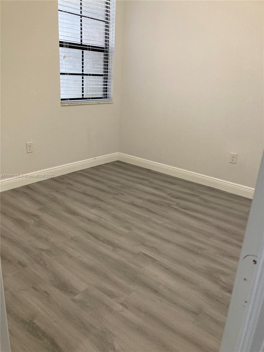 The Hammocks Miami, FL 33196 - Photo 26 of 27 an empty room with wooden floor and cabinet