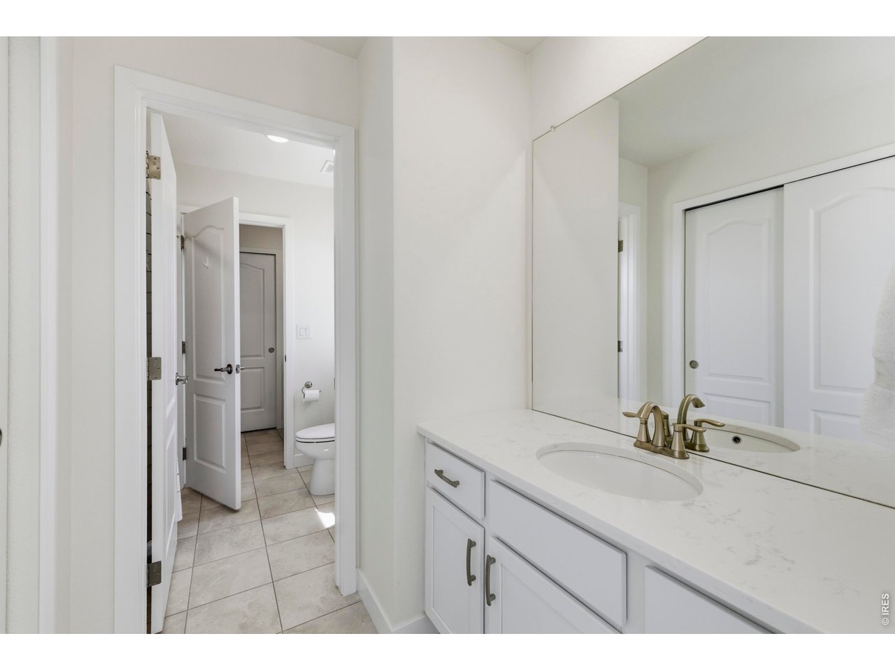 2910 Water View Street Timnath, CO 80547 - Photo 30 of 50 a bathroom with a sink double vanity and a mirror