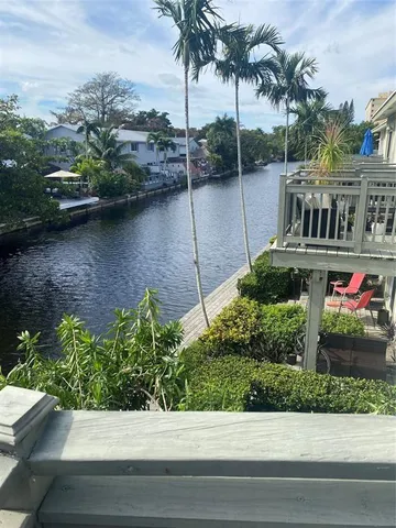 a view of a garden with cars parked