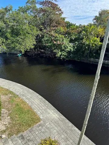 a view of a lake with a house in the background
