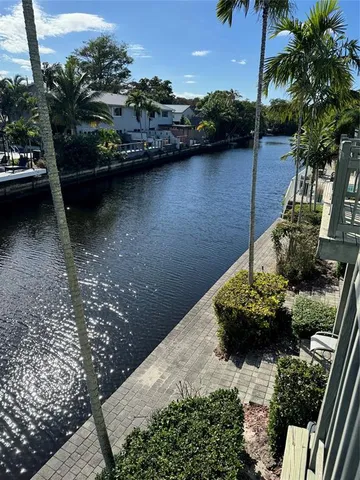 a view of a lake with large trees