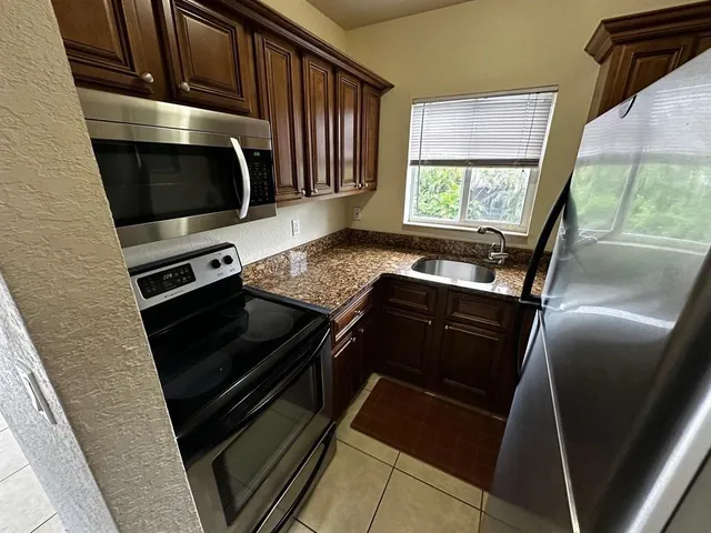 a kitchen with a stove microwave and sink