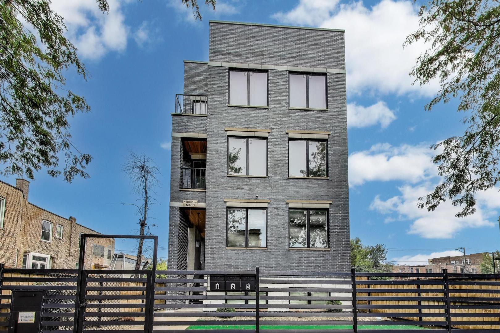 6363 South Ellis Avenue, Unit 2 Chicago, IL 60637 - Photo 1 of 18 a front view of a house with a yard