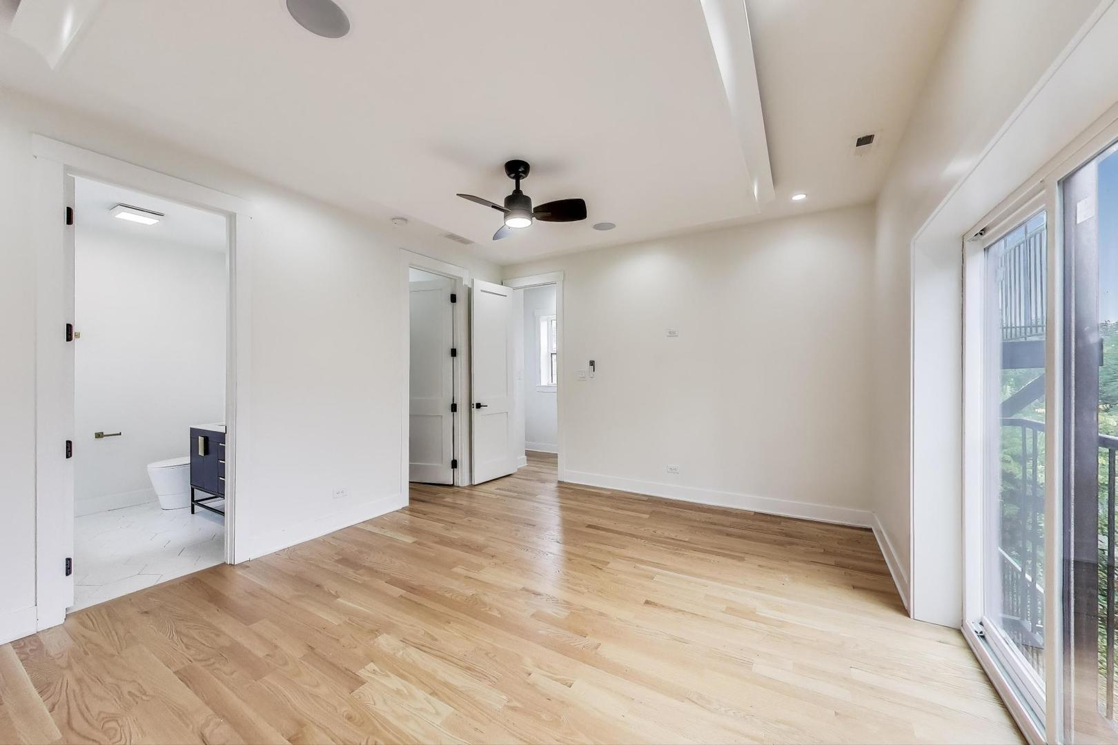 6363 South Ellis Avenue, Unit 2 Chicago, IL 60637 - Photo 7 of 18 wooden floor in an empty room with a window