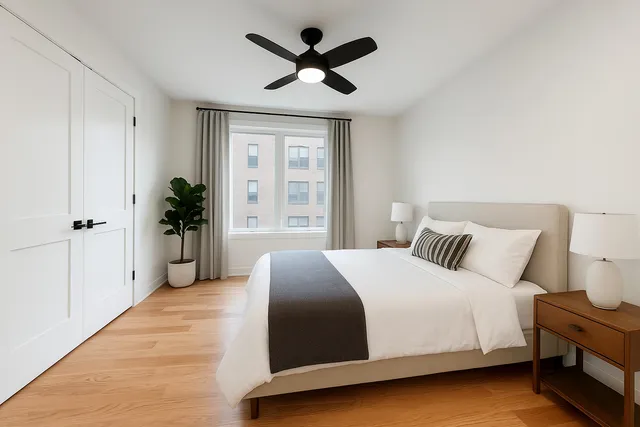 a spacious bedroom with a bed and a ceiling fan