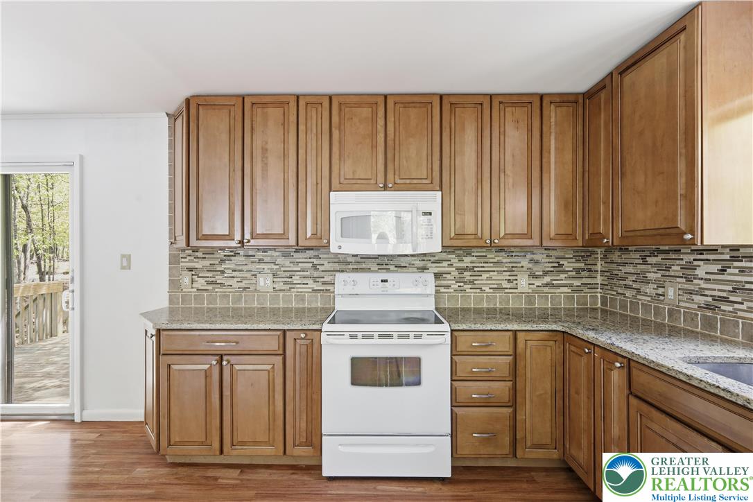 505 Chipmunk Road Bushkill, PA 18324 - Photo 11 of 46 a kitchen with stainless steel appliances white cabinets and a stove top oven