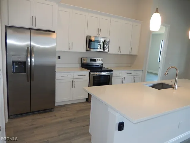 a kitchen with a sink a stove and refrigerator