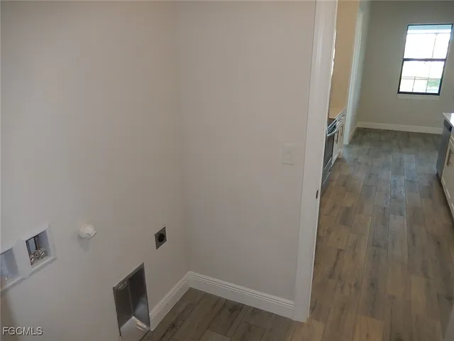 a view of a room with wooden floor and windows