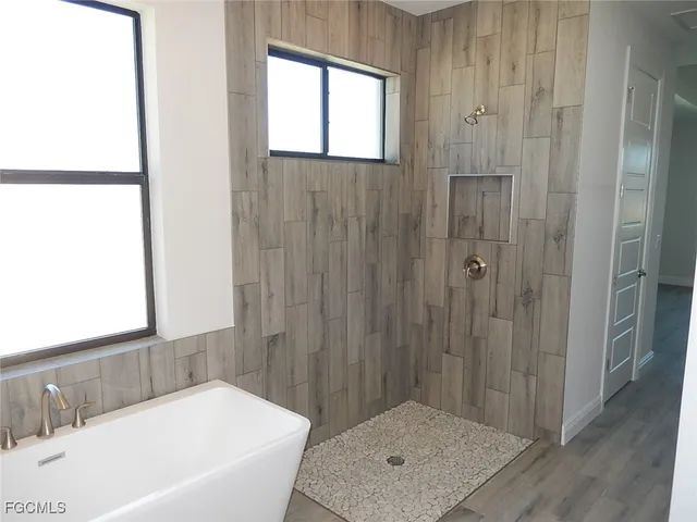 a bathroom with a tub shower and a sink