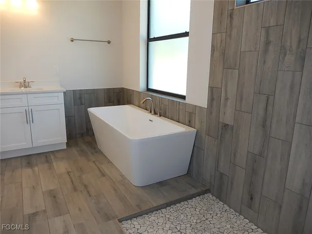 a bathroom with a bathtub and sink
