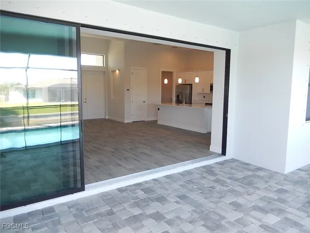 an empty room with sliding glass door and shower
