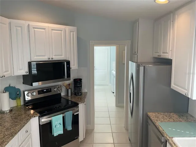 a kitchen with metallic refrigerator freezer and a dishwasher