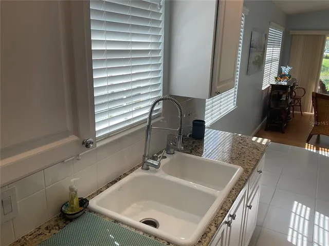 a kitchen with stainless steel appliances granite countertop a stove top oven a sink dishwasher and cabinets