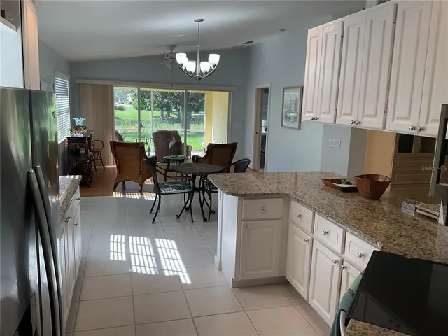 a kitchen with stainless steel appliances a stove a microwave and white cabinets
