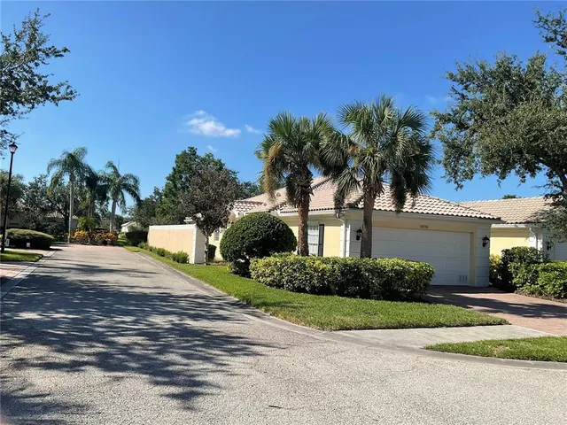 a front view of a house with a garden and a yard