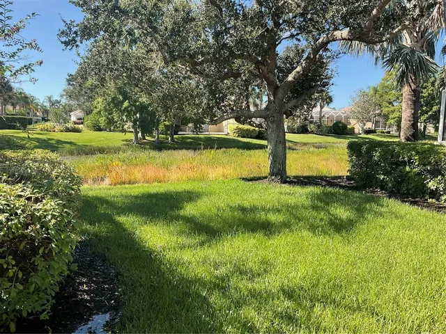 a bedroom with a bed and a flat tv screen on the dresser
