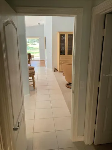 a front view of a house with a yard and fountain in middle