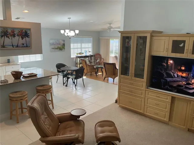 a living room with furniture a couch and white walls