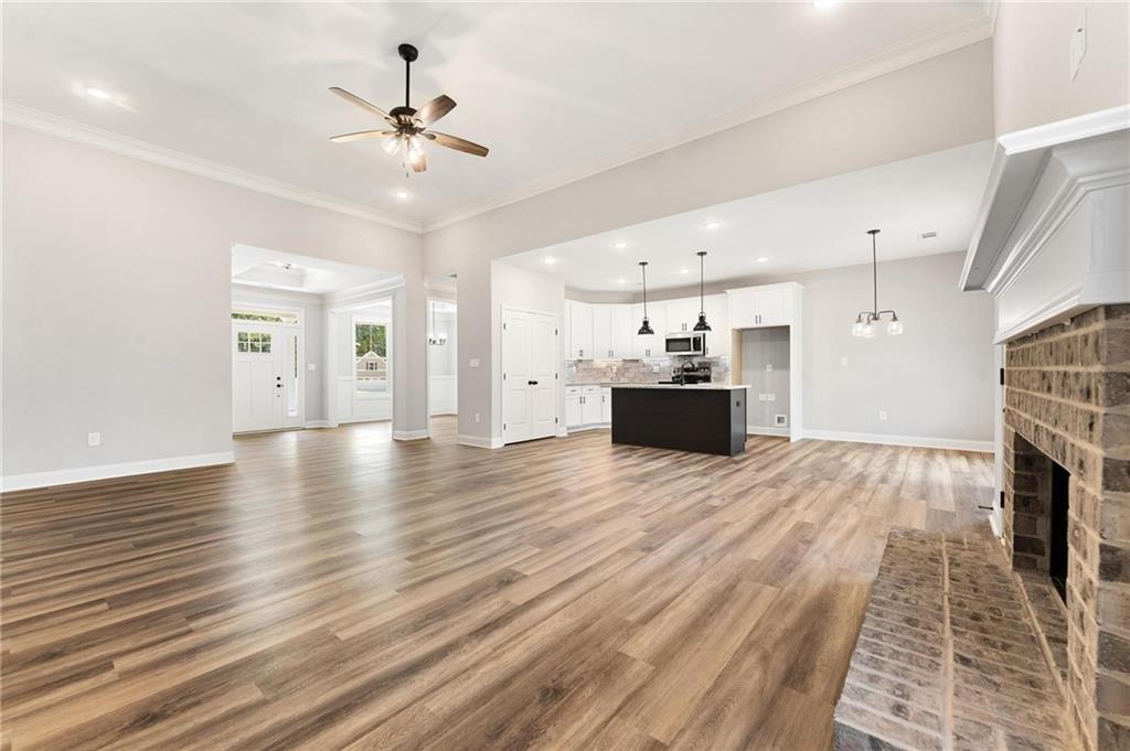 280 Camden Loop Jefferson, GA 30549 - Photo 11 of 43 a view of a livingroom with wooden floor and a ceiling fan