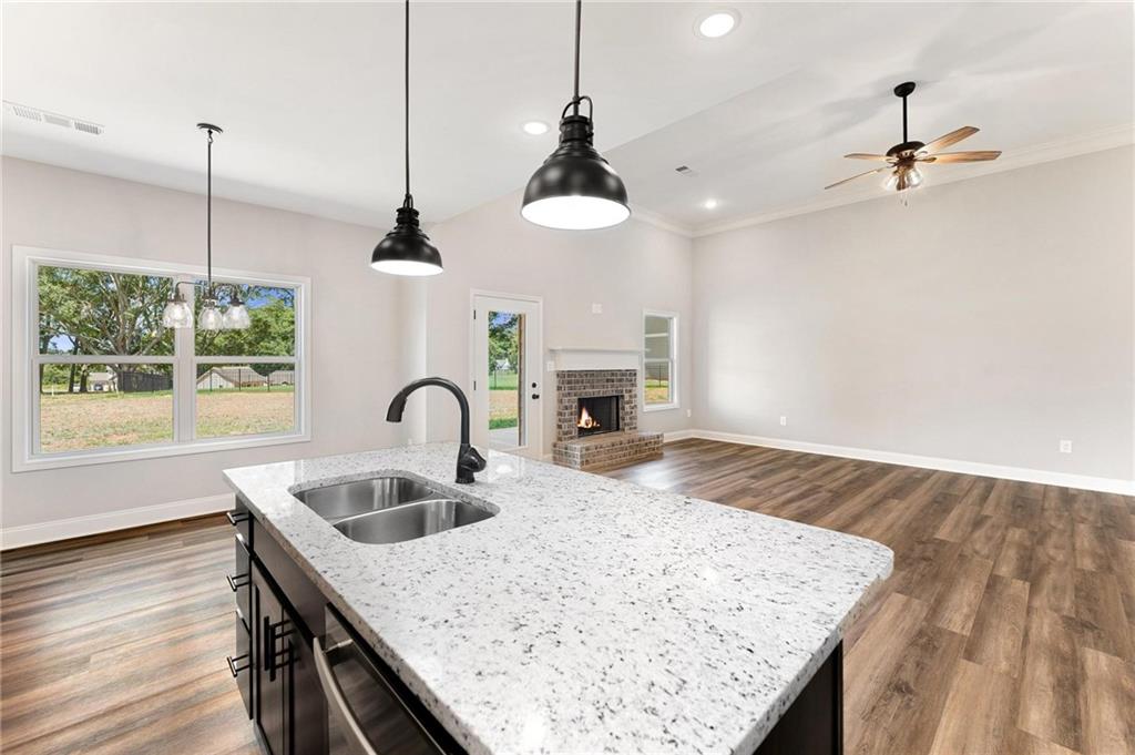 280 Camden Loop Jefferson, GA 30549 - Photo 13 of 43 a kitchen with kitchen island stainless steel appliances sink stove refrigerator and wooden floor