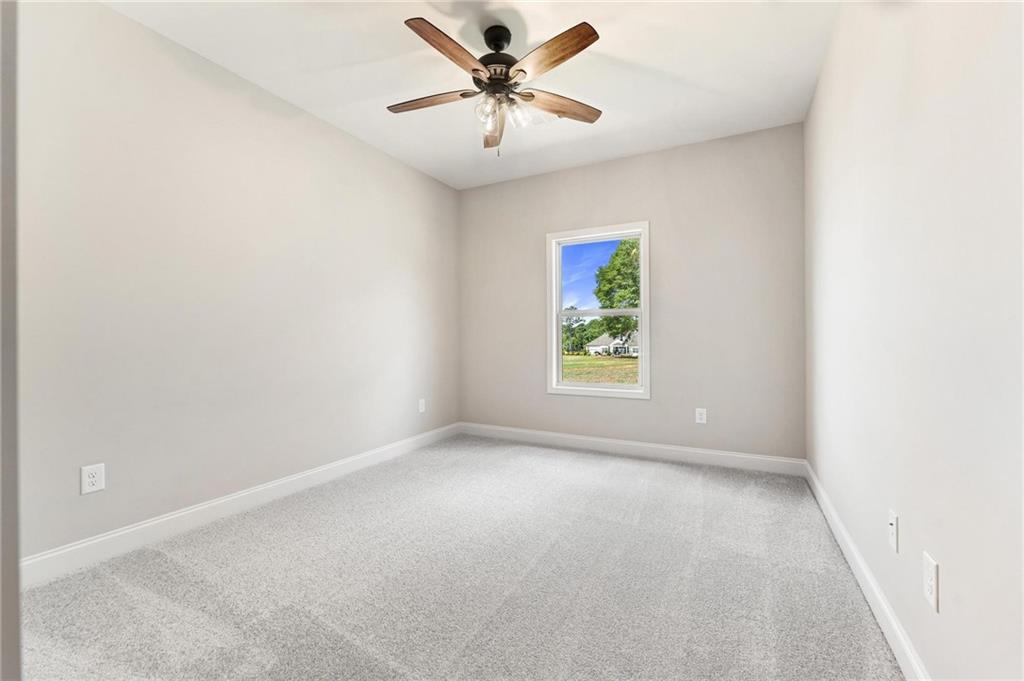 280 Camden Loop Jefferson, GA 30549 - Photo 23 of 43 an empty room with windows and fan