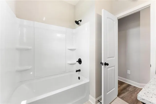 a view of a room with a window and a ceiling fan