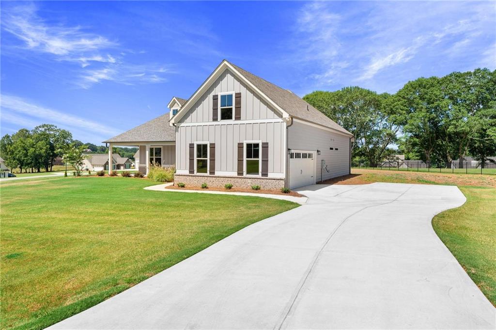 280 Camden Loop Jefferson, GA 30549 - Photo 3 of 43 a front view of a house with a yard