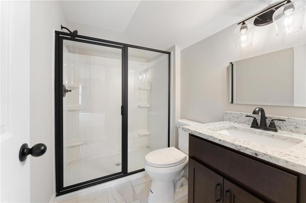 280 Camden Loop Jefferson, GA 30549 - Photo 33 of 43 a bathroom with a granite countertop sink toilet and shower