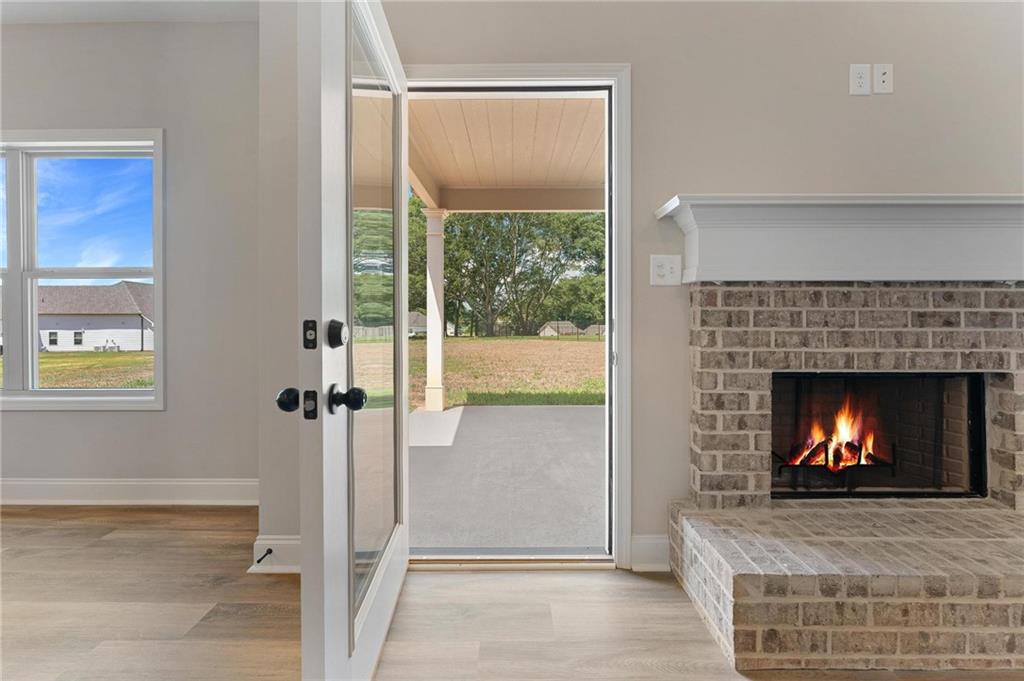 280 Camden Loop Jefferson, GA 30549 - Photo 37 of 43 a view of an empty room with a fireplace and a window