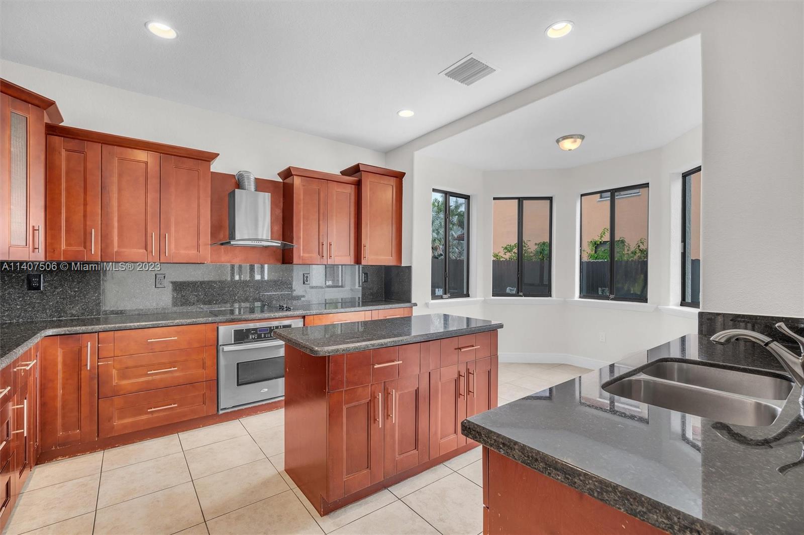 Tamiami Miami, FL 33184 - Photo 11 of 46 a kitchen with stainless steel appliances granite countertop a sink and cabinets