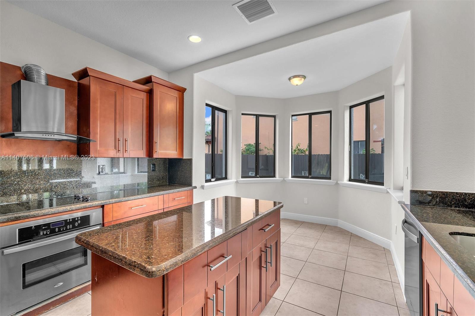 Tamiami Miami, FL 33184 - Photo 12 of 46 a kitchen with a stove a sink and a refrigerator