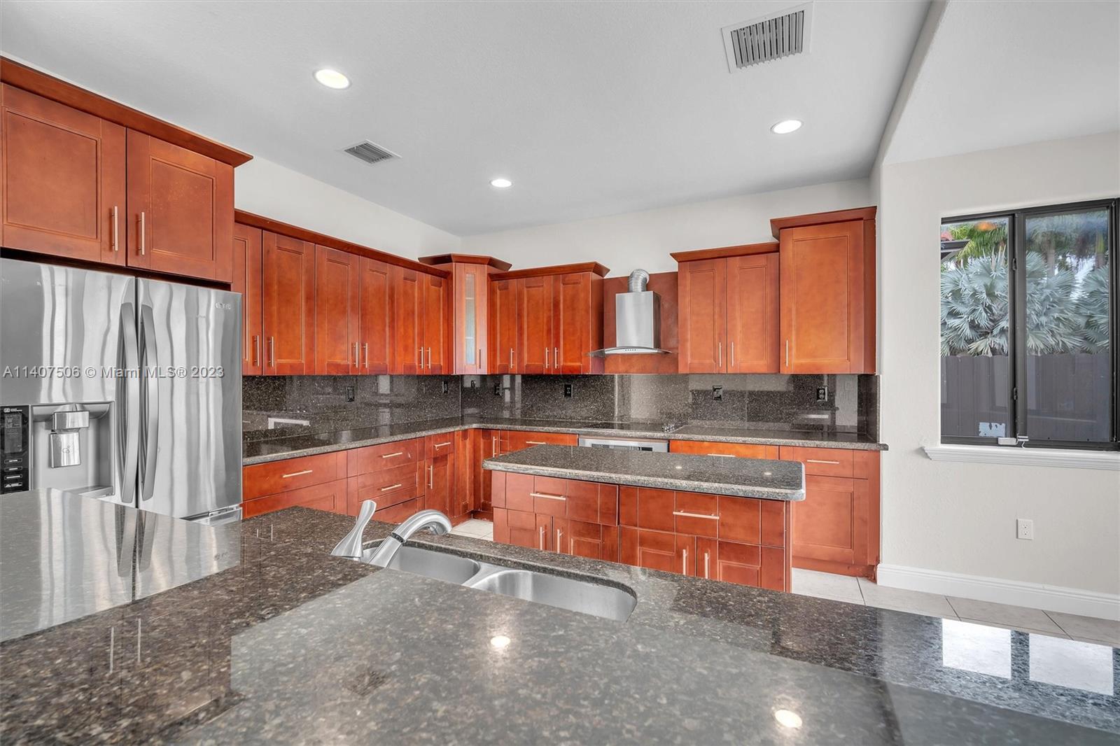 Tamiami Miami, FL 33184 - Photo 13 of 46 a large kitchen with stainless steel appliances granite countertop a refrigerator and a stove