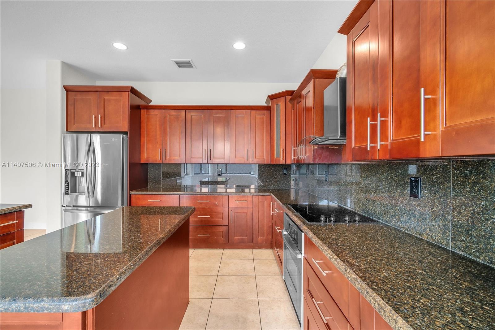 Tamiami Miami, FL 33184 - Photo 14 of 46 a kitchen with stainless steel appliances granite countertop a sink and cabinets