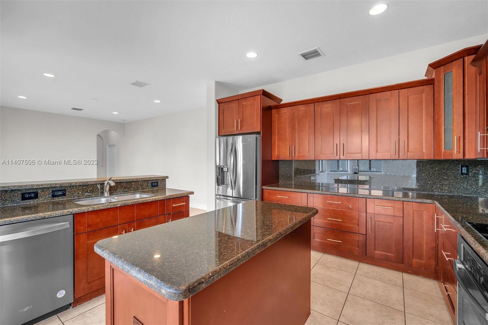 Tamiami Miami, FL 33184 - Photo 15 of 46 a kitchen with stainless steel appliances granite countertop a sink a stove and a refrigerator