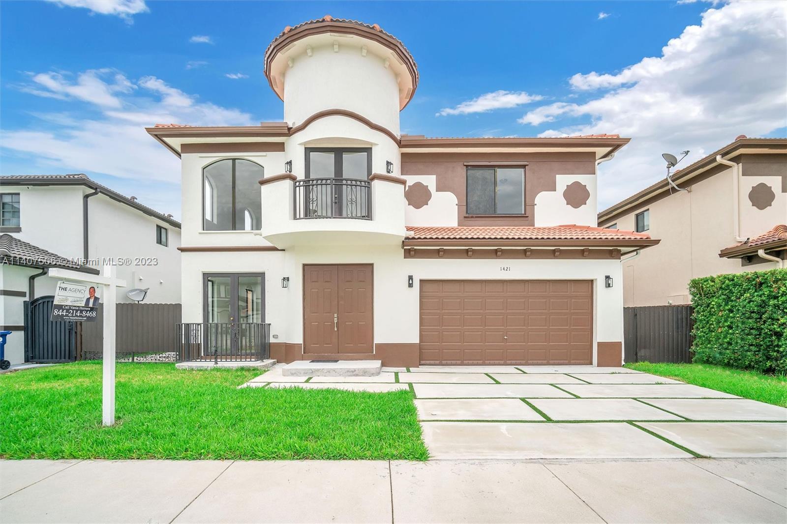 Tamiami Miami, FL 33184 - Photo 2 of 46 a front view of a house with a garden and yard