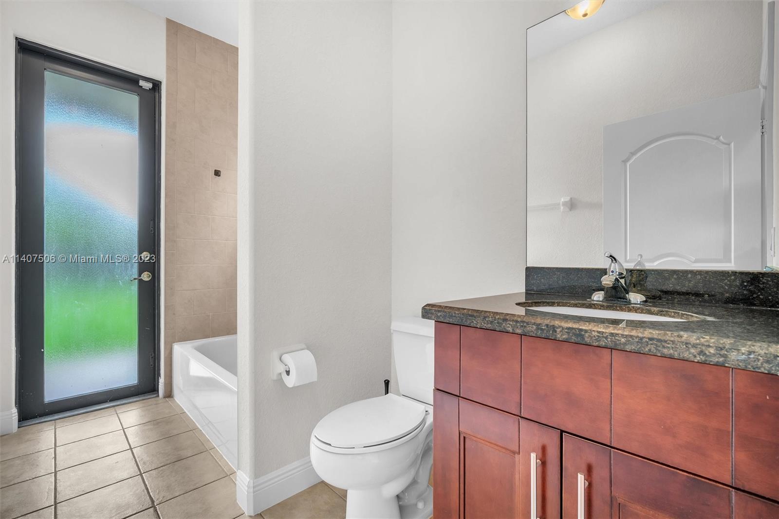 Tamiami Miami, FL 33184 - Photo 21 of 46 a bathroom with a granite countertop sink a toilet and a mirror