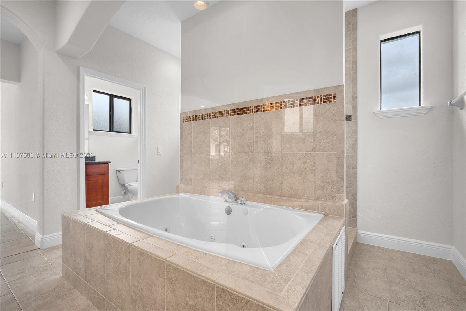 Tamiami Miami, FL 33184 - Photo 28 of 46 a bathroom with a tub and shower