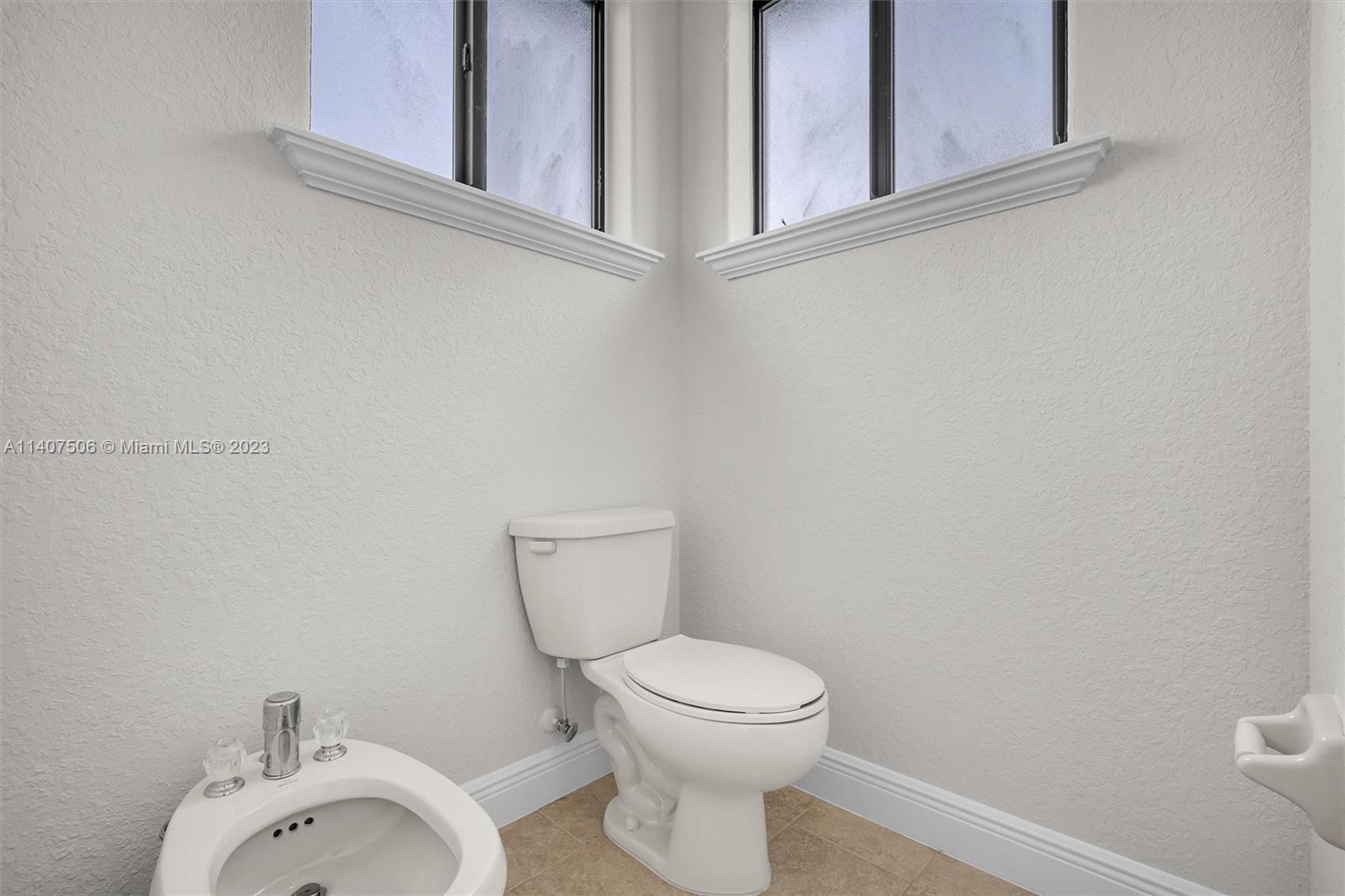 Tamiami Miami, FL 33184 - Photo 30 of 46 a white toilet sitting next to a bathroom sink