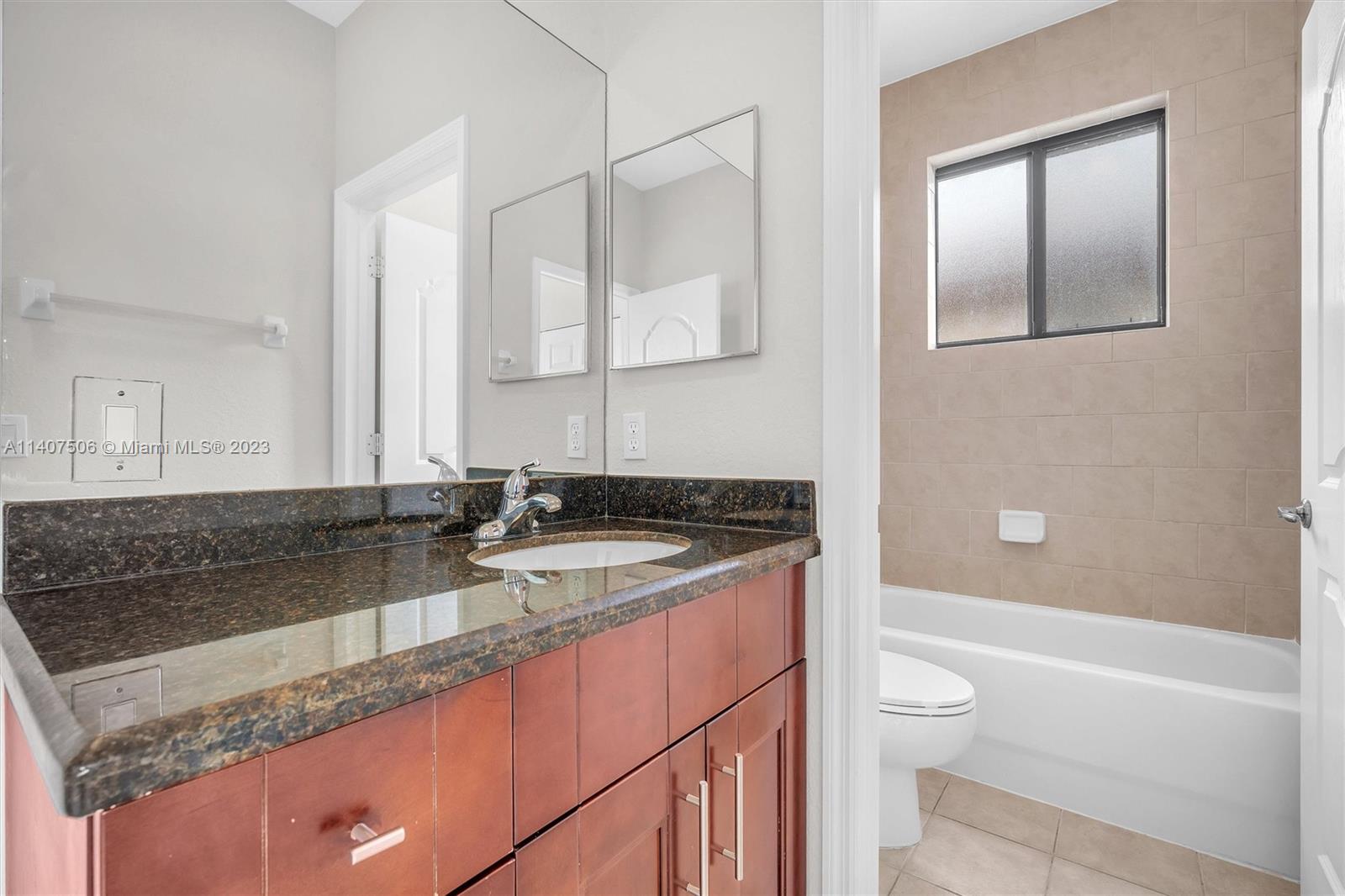 Tamiami Miami, FL 33184 - Photo 33 of 46 a bathroom with a granite countertop sink a toilet and bathtub