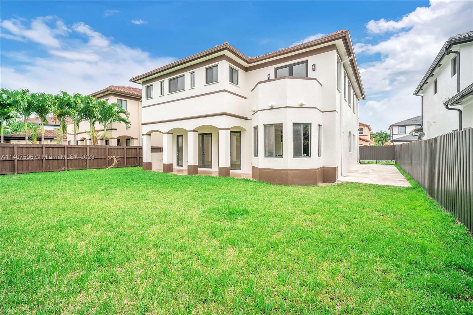 Tamiami Miami, FL 33184 - Photo 43 of 46 a front view of a house with a yard and trees