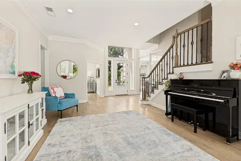 a kitchen with stainless steel appliances granite countertop a table chairs microwave and sink