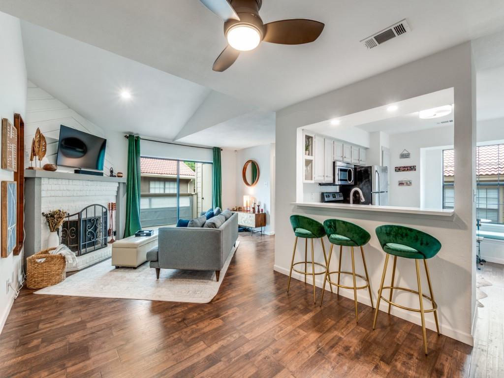 5200 Martel Avenue, Unit 6Q Dallas, TX 75206 - Photo 12 of 32 a living room with furniture a fireplace and a flat screen tv
