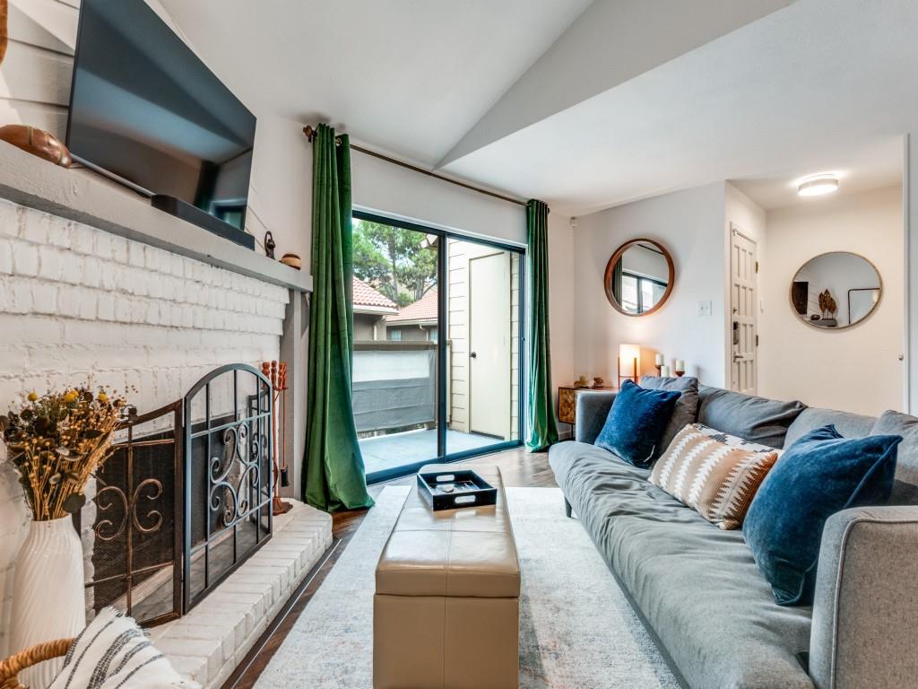 5200 Martel Avenue, Unit 6Q Dallas, TX 75206 - Photo 6 of 32 a living room with furniture a fireplace and a flat screen tv