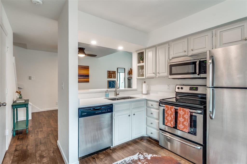 5200 Martel Avenue, Unit 6Q Dallas, TX 75206 - Photo 8 of 32 a kitchen with stainless steel appliances granite countertop a stove top oven a sink and dishwasher