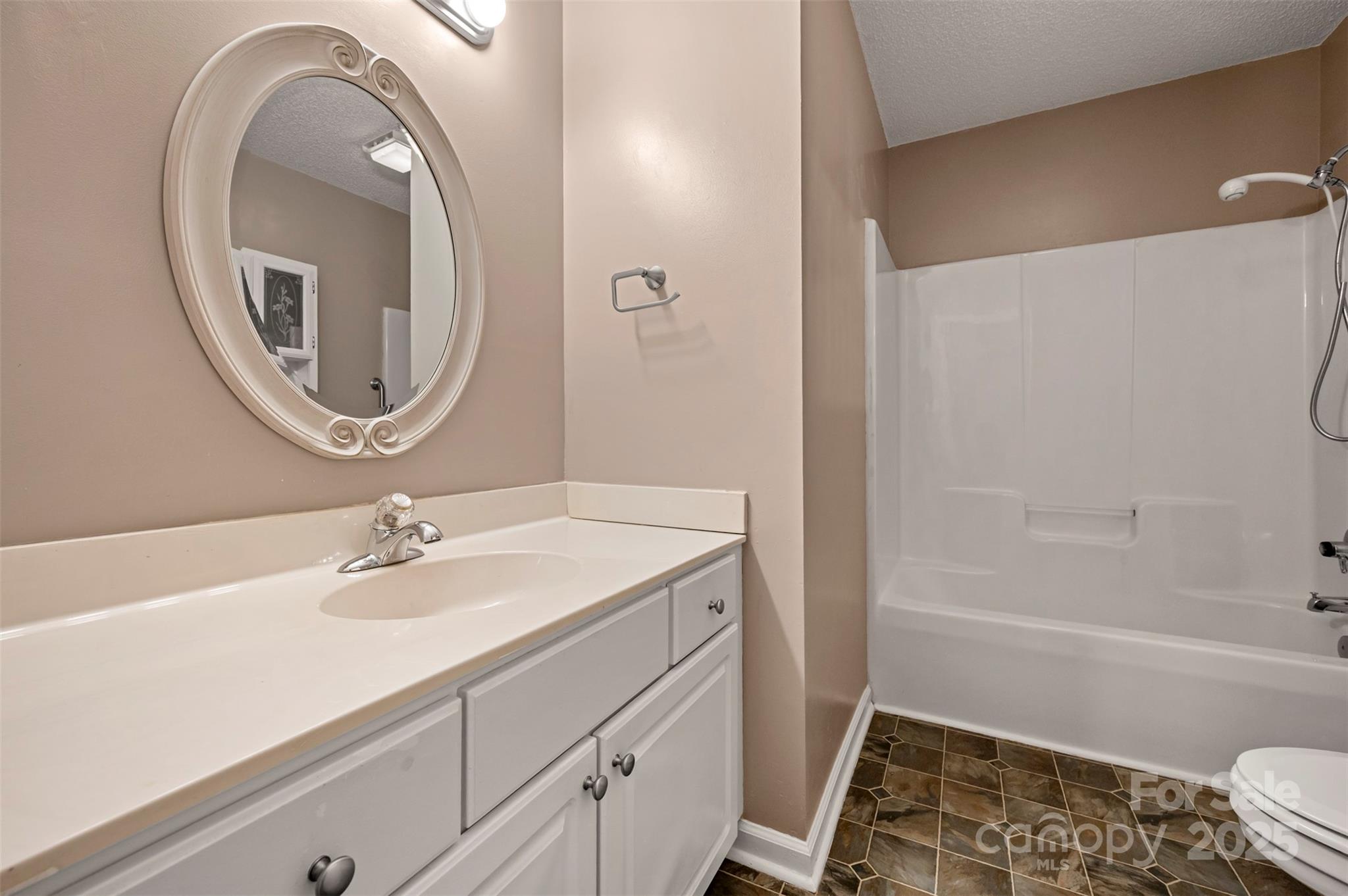 506 Pleasant Street Spindale, NC 28160 - Photo 14 of 34 a bathroom with a sink and a mirror