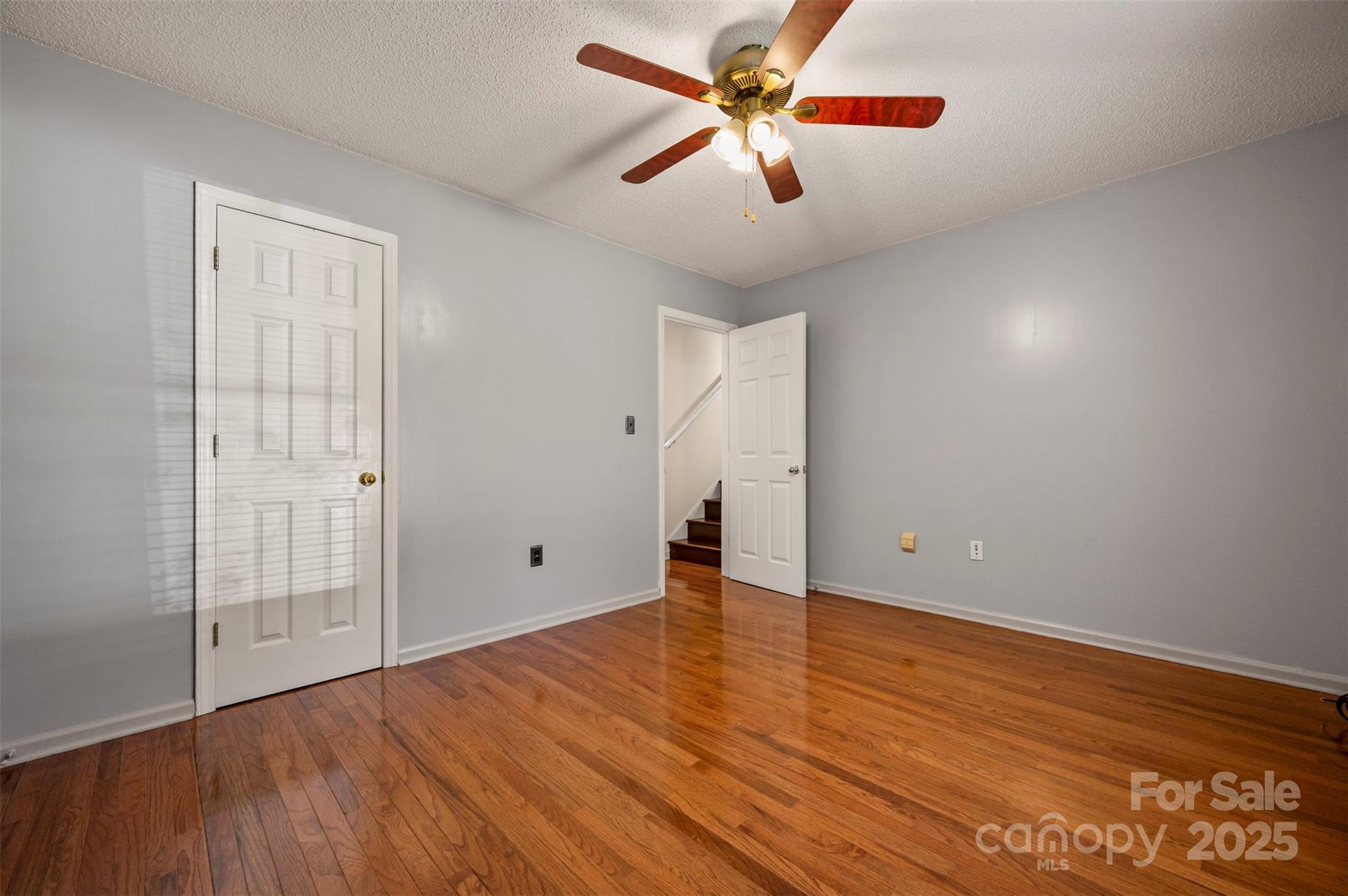 506 Pleasant Street Spindale, NC 28160 - Photo 16 of 34 an empty room with wooden floor and windows