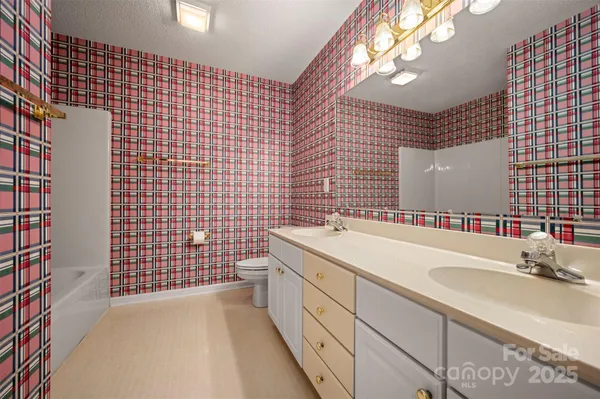 a bathroom with a sink a vanity granite and a shower